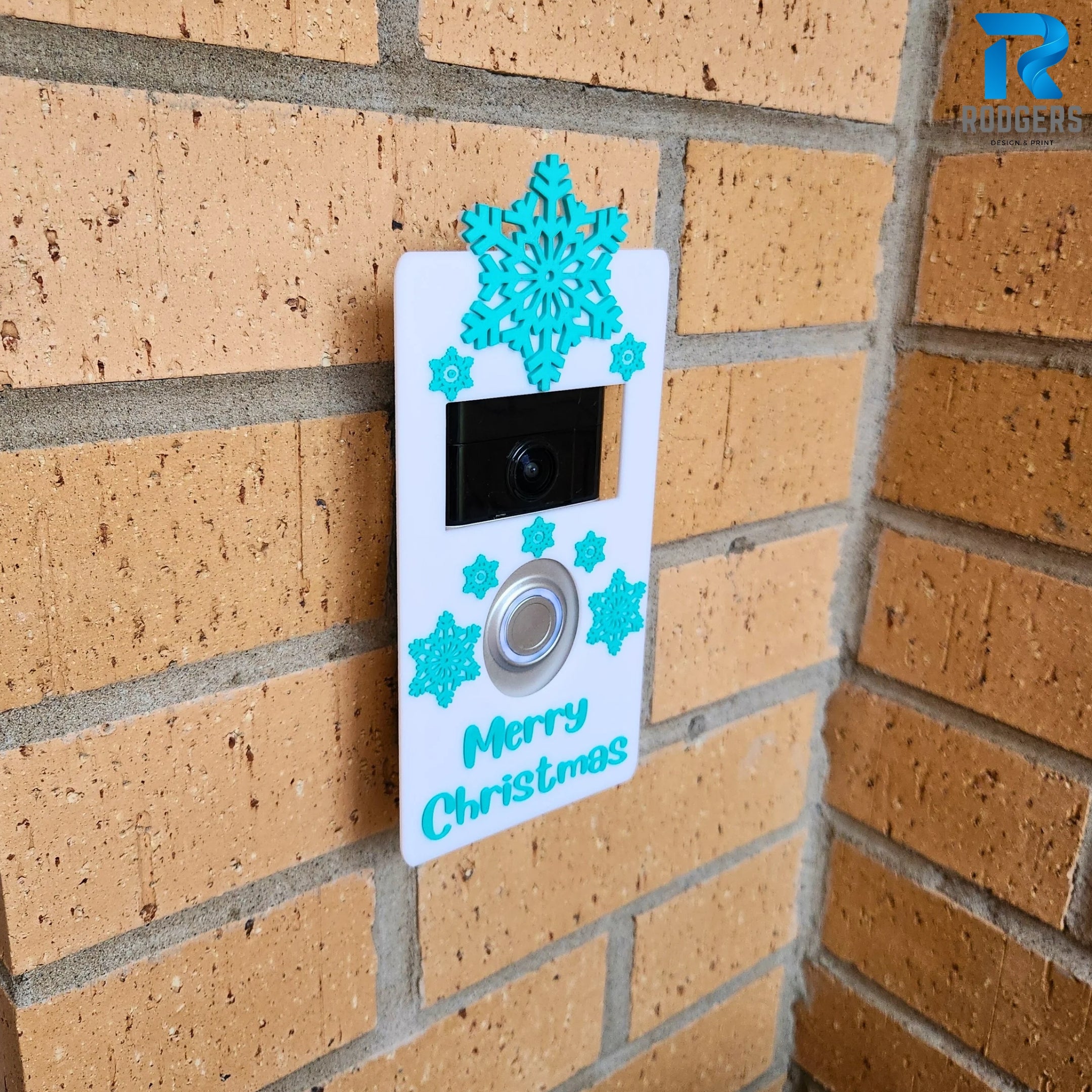 Snowflake patterned Ring Doorbell cover displayed against a holiday themed backdrop