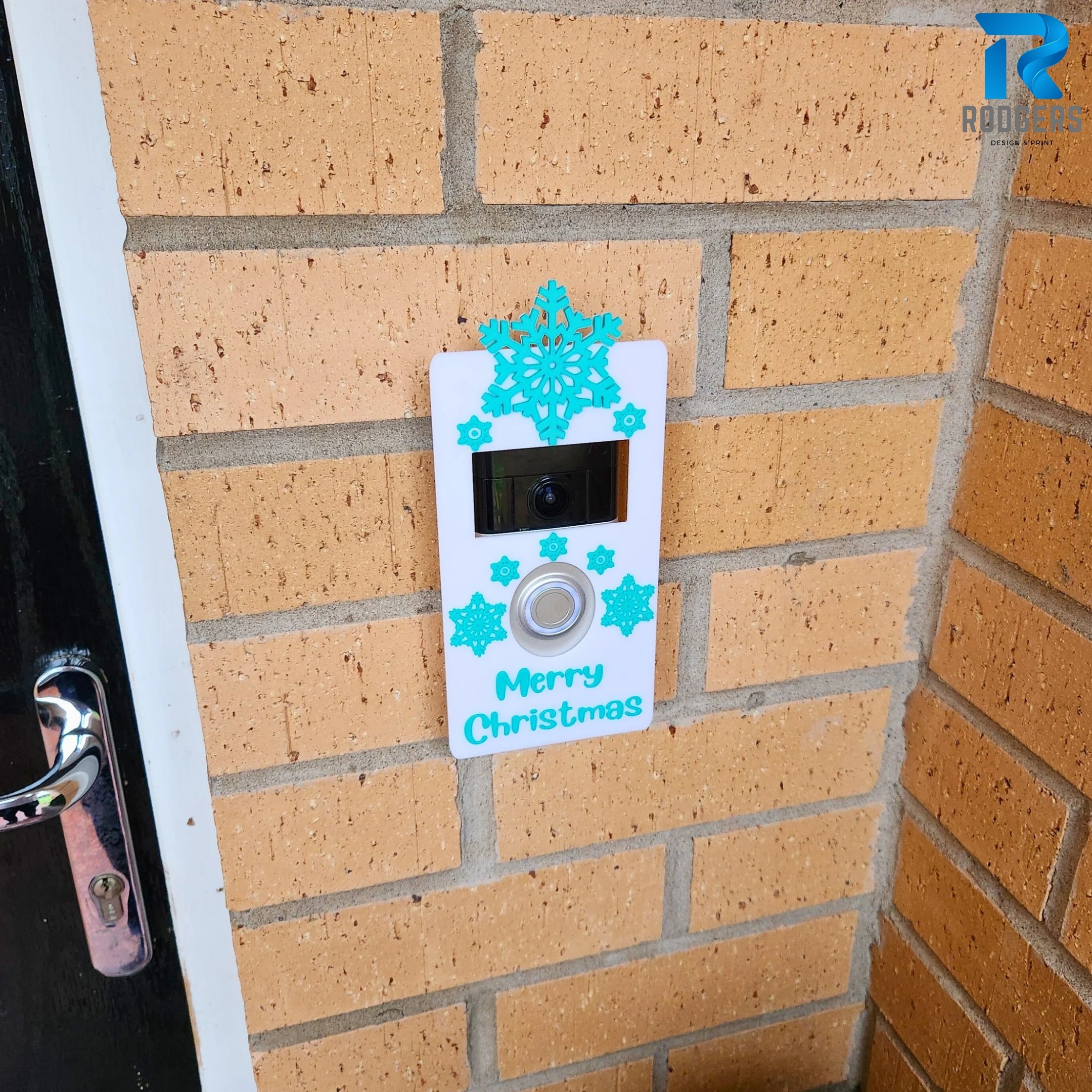 Close up of snowflake design on Ring Doorbell cover with cyan details